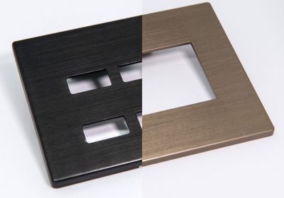 Why does the aluminum part have a visible grain structure through anodizing?